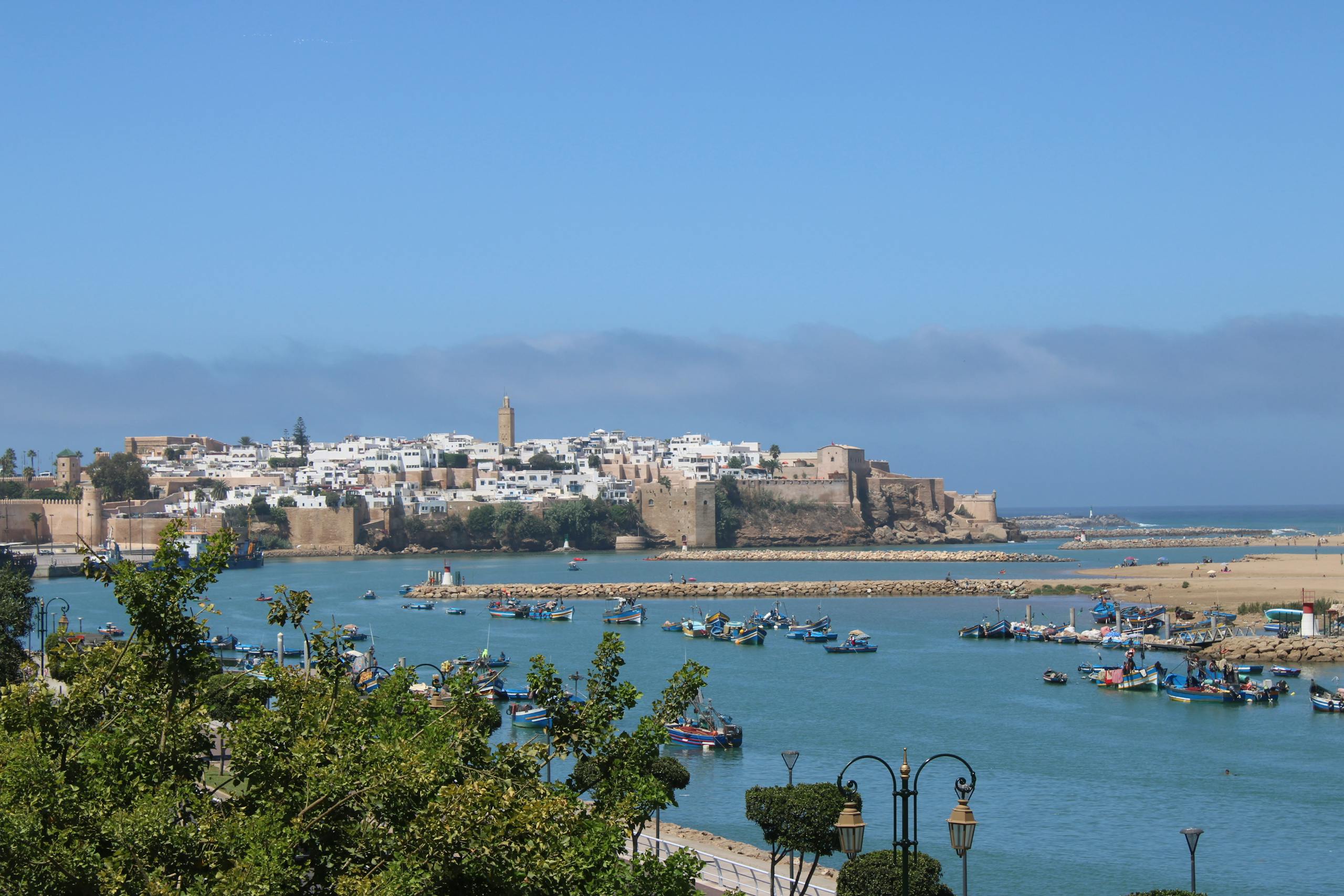 Scenic capture of Rabat's historical coastal front with inviting blue waters and vibrant skies.